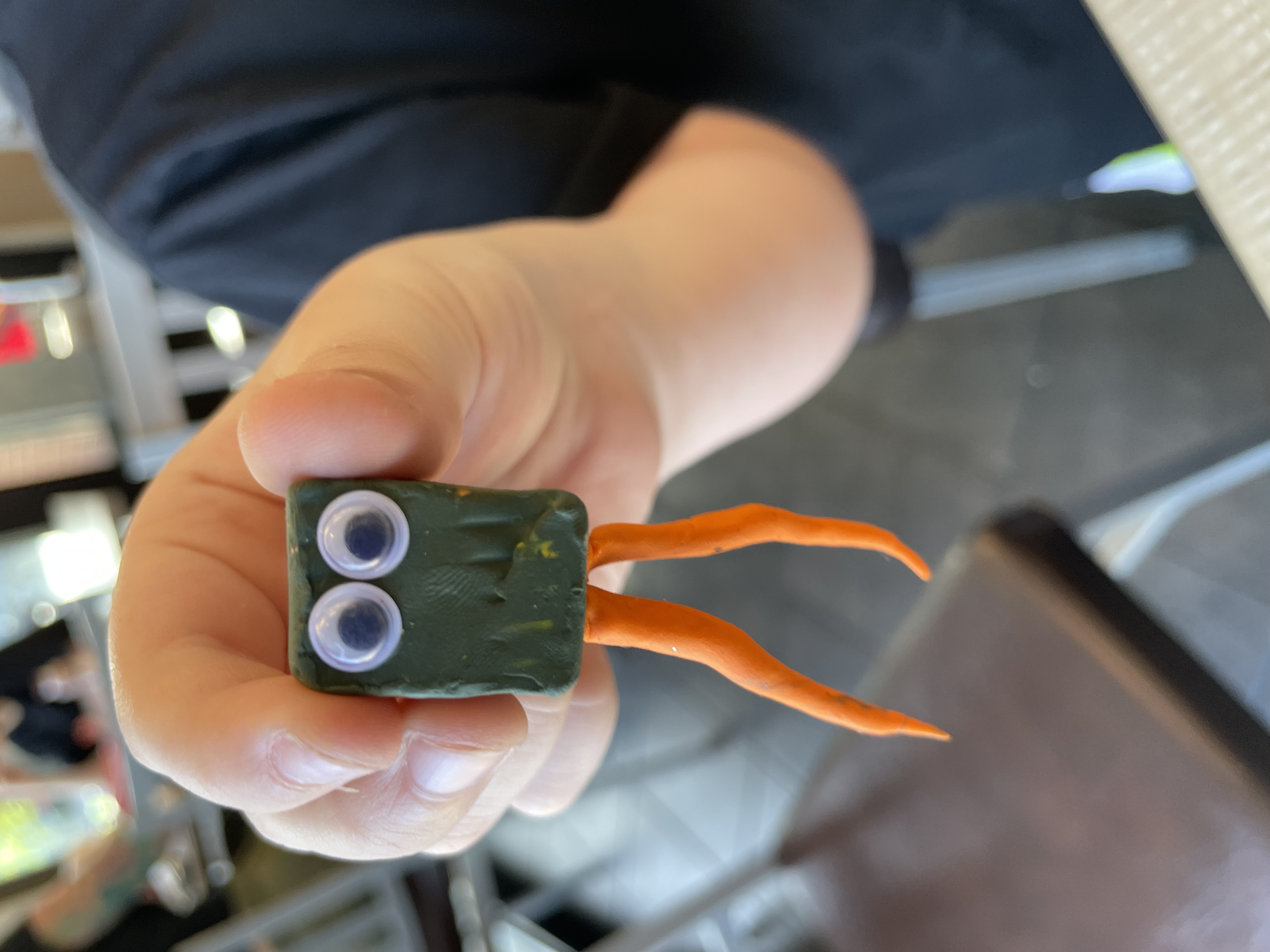 Smiling child with clay Toco Toucan