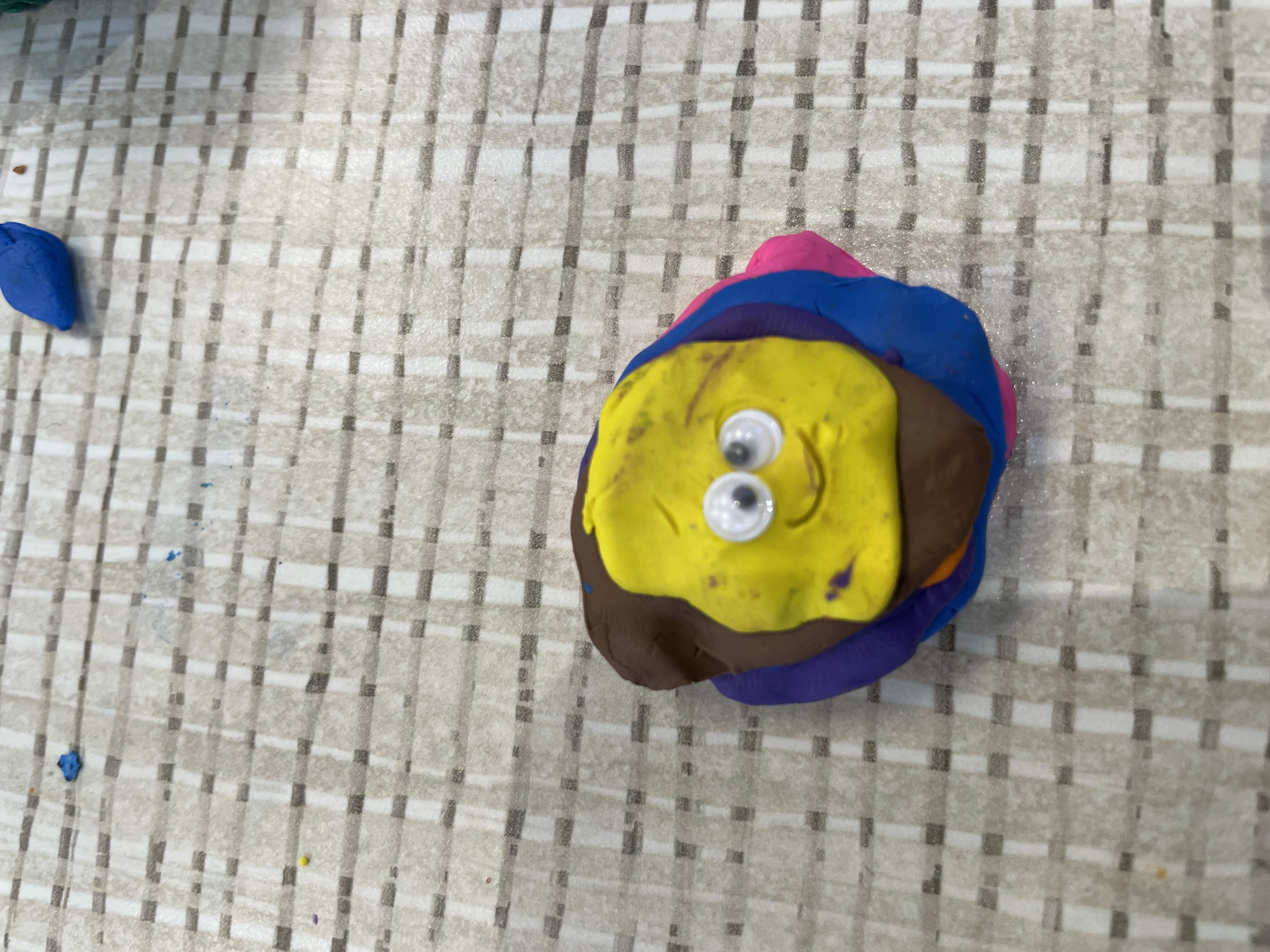 Clay Toco Toucan with large green and yellow beak and googly eye, viewed from above